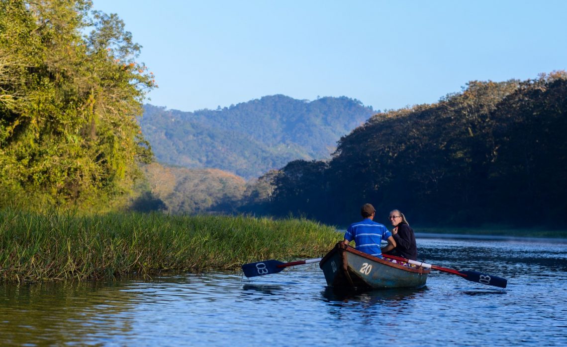Birding guests in a wooden rowboat on Lake Yojoa