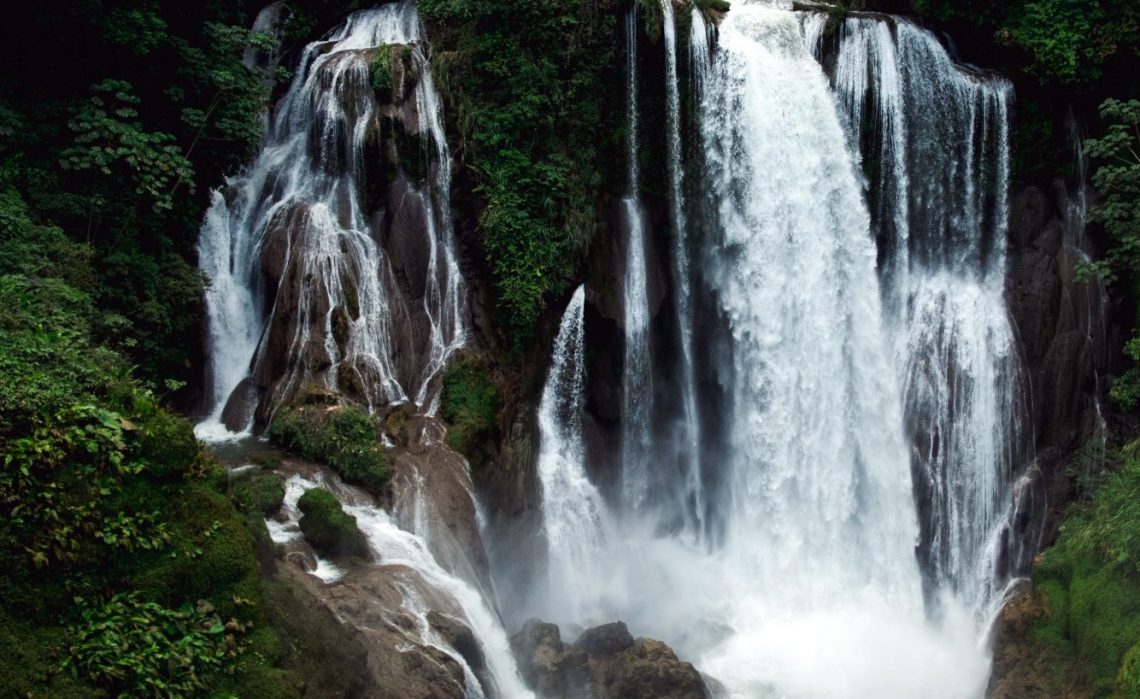 Waterfall cascading through lush tropical rainforest near Lake Yojoa